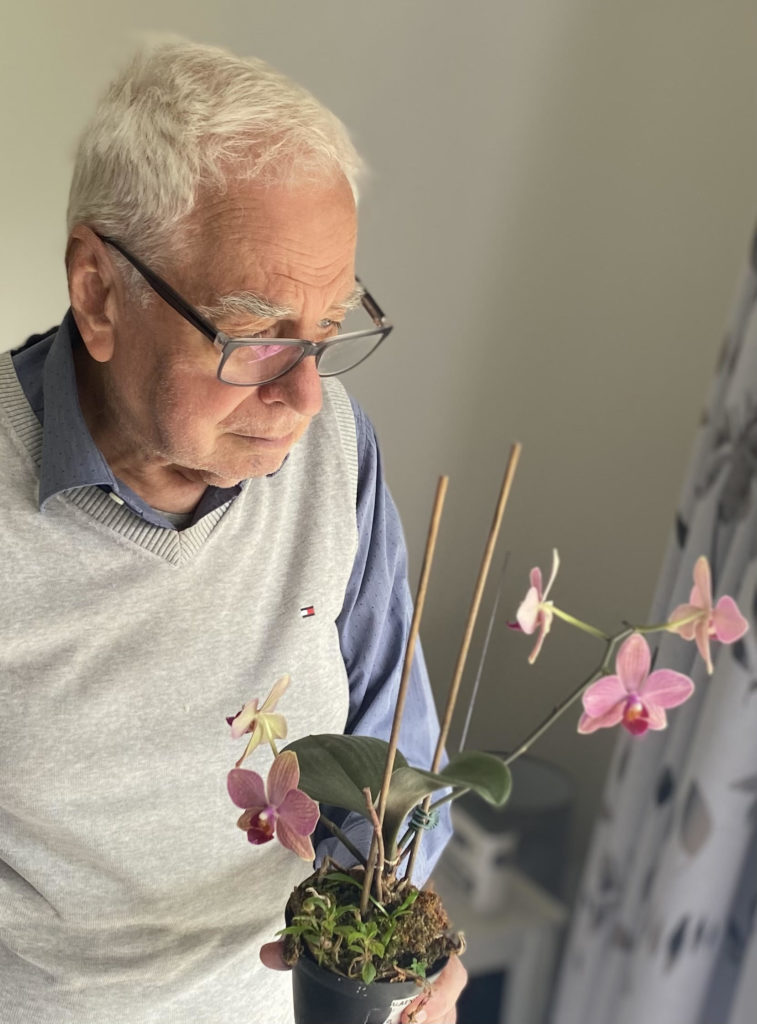 This Flies researcher David McAlpine holding an orchid pot plant. 