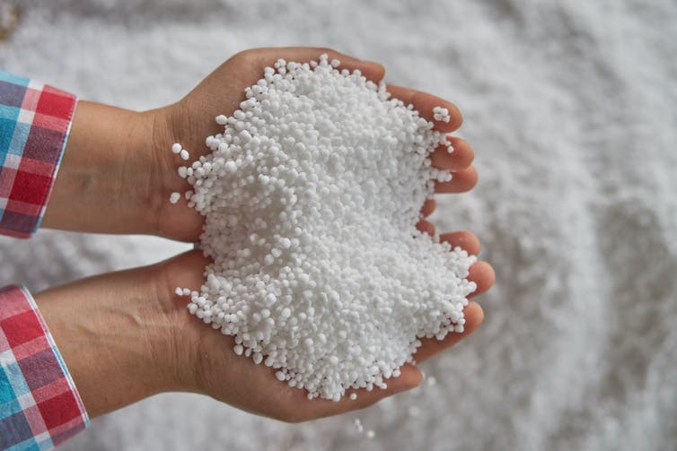 Hands holding white beads