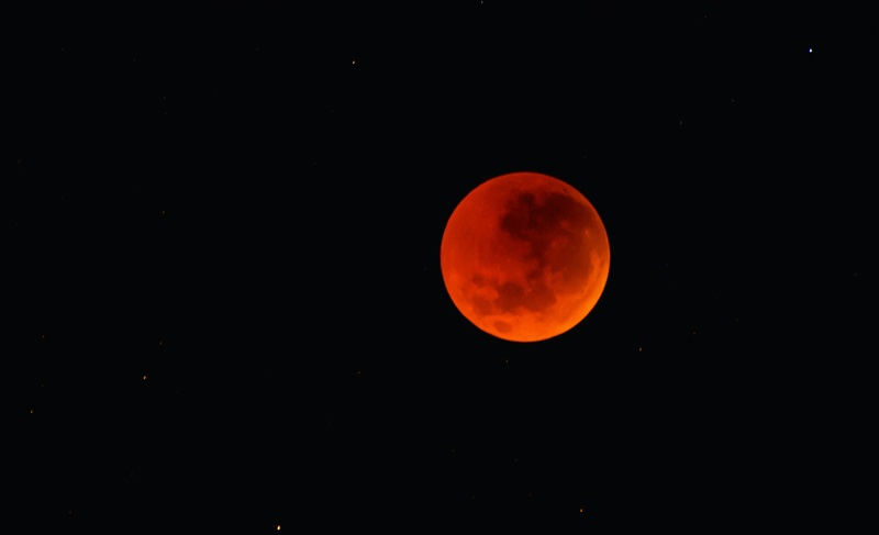 Total lunar eclipse (red moon) in black sky 