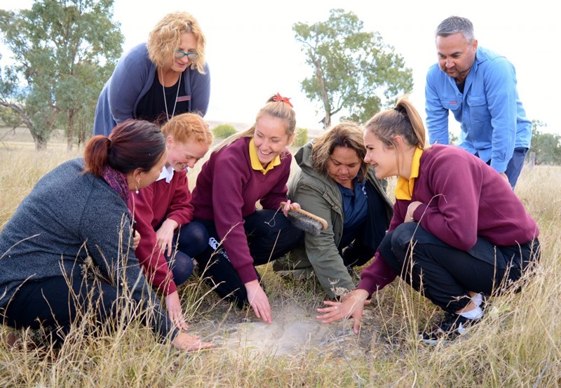 Students Georgie Auld, Lillie Clark and Tyra Nean learning about how sandstone beds were used in axe production with Deputy Principal Catherine Loughrey, Kamilaroi man Corie Taylor, Aboriginal Education Officer Megan Outerbridge and Student Support Leaving Officer Georgina Riley. Photo courtesy of Quirindi High School.