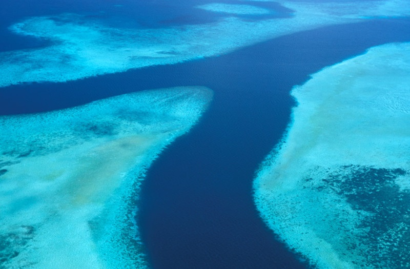 An areial photo of a reef system and channel waters in Palau.