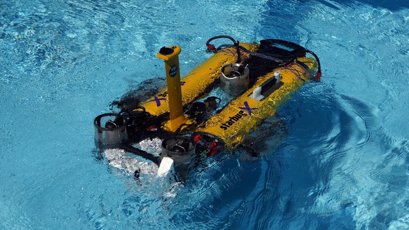 close up of yellow, mini-submarine on water surface
