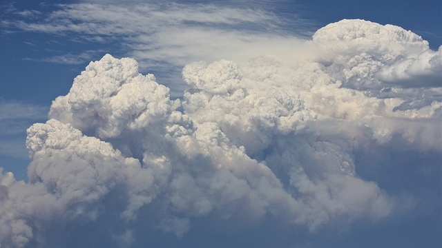 bushfire smoke plumes against blue sky