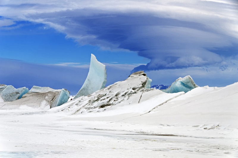 Icy landscape with cloud formation above