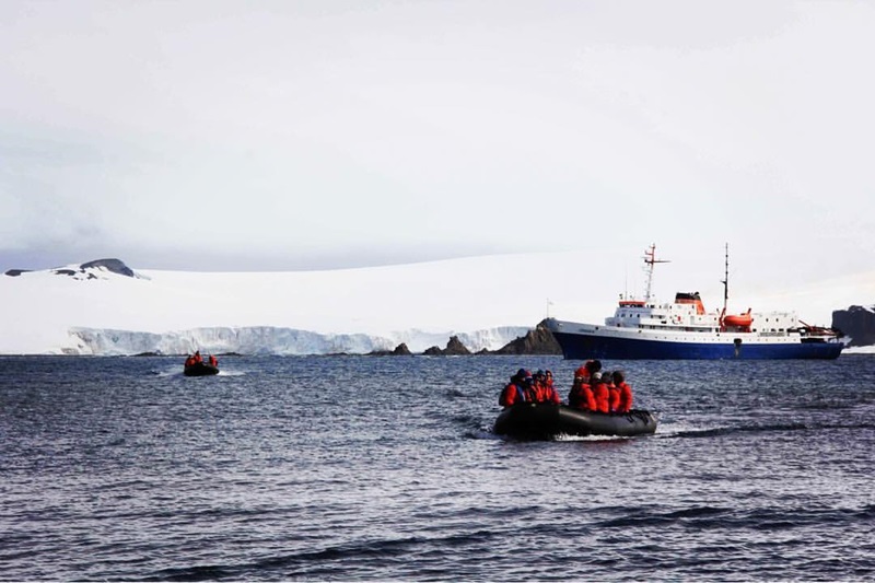 dinghy leaving main boat with snow/ice background