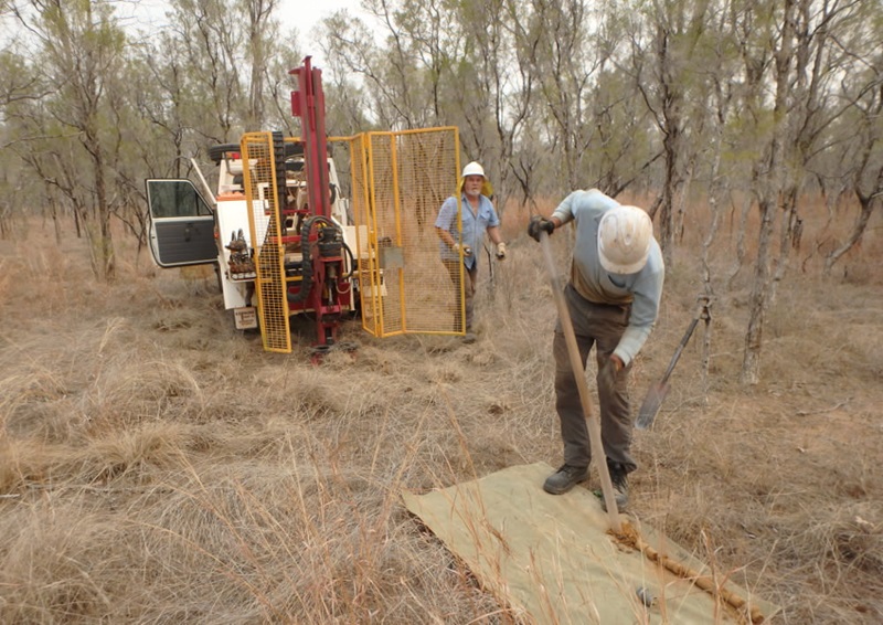 two men and a soil sampling rig at work