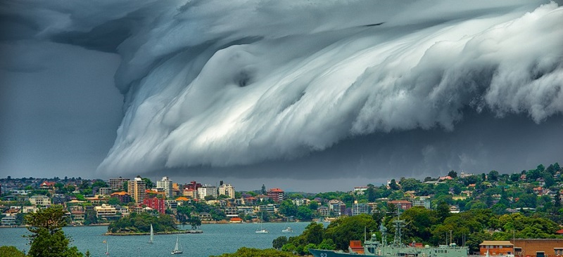 A large storm depicted by rolling grey clouds looms in the sky above Sydney Harbour. Image Richard Hirst.