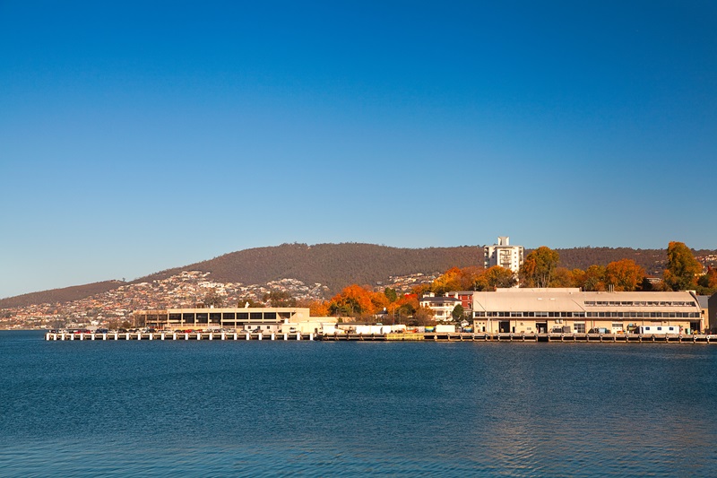 Buildings on the water with mountains in the background
