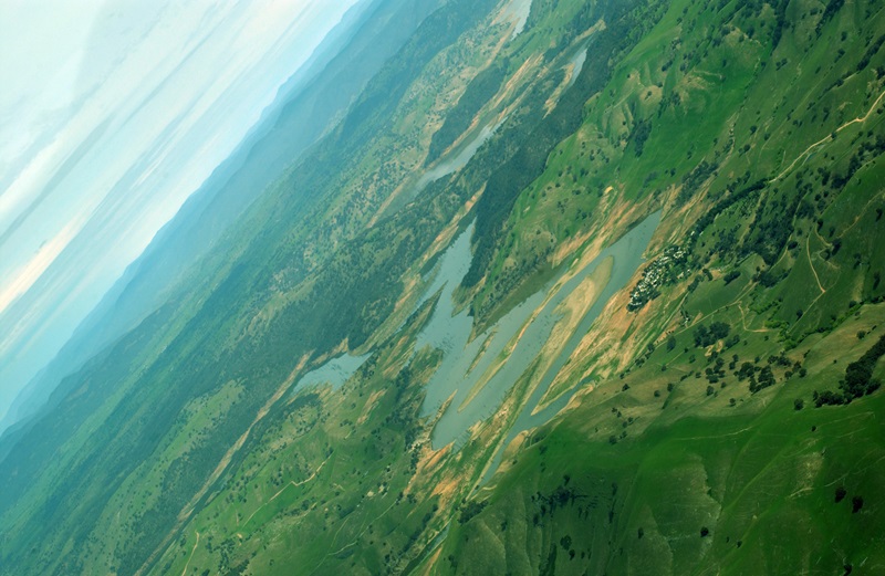 Aerial view of river surrounded by green landscape