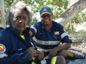 Two women with navy blue shirts on in the bush