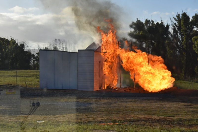A house burns during fire testing at the Mogo Bushfire Burnover Facility in NSW during February 2021.