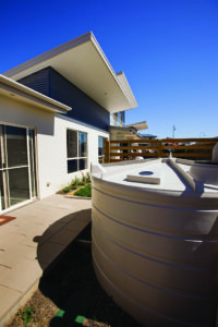 A rainwater tank in back courtyard of a house