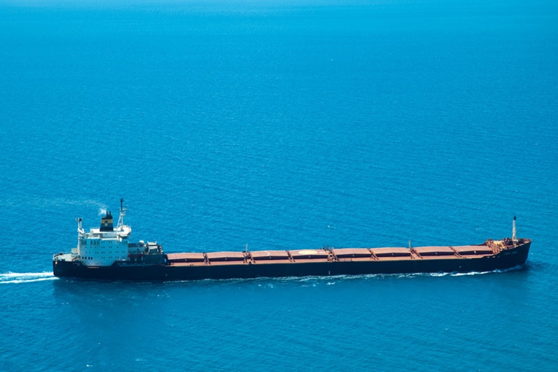 A bulk carrier on bright blue water