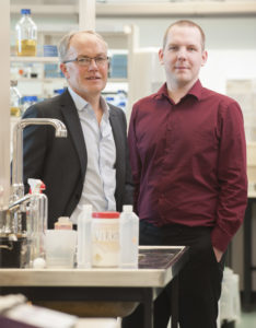 Two men standing in a lab