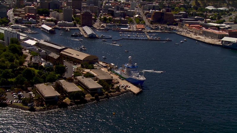 Aerial view of a harbour with a ship moored next to a row of buildings