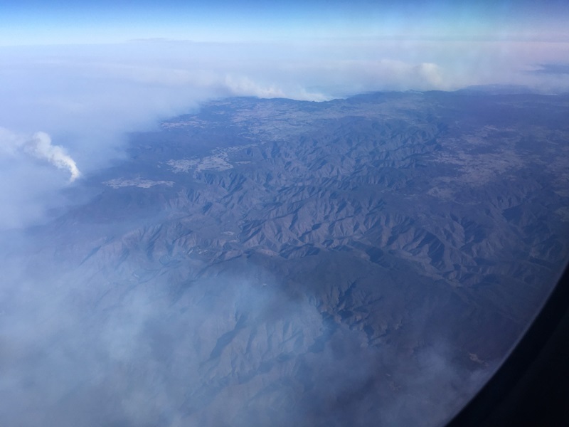 arial photo of mountainous landscape showing smoke from bushfire