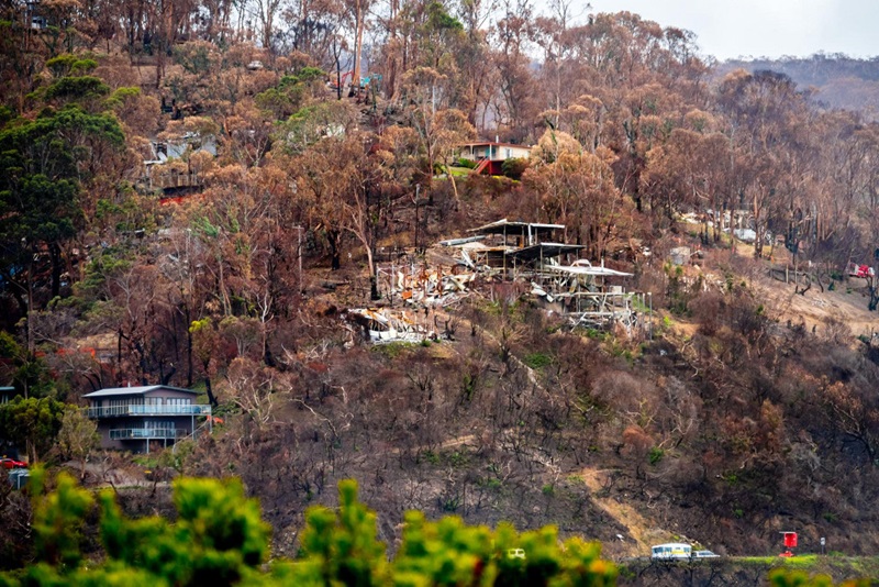 burnt out houses on hill slope