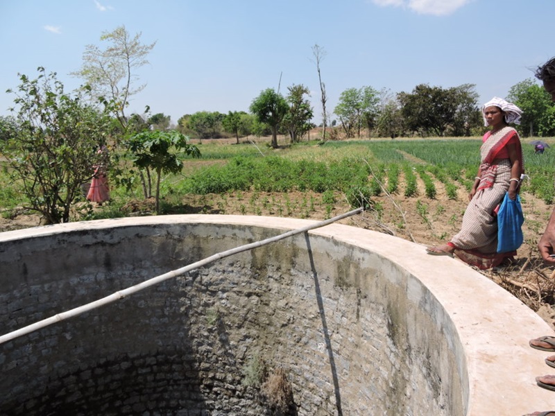 Woman standing at edge of well