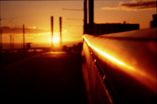 Sun reflecting off a hand rail in the city. 