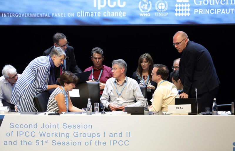 Nine people seated behind a panel as part of the IPCC Joint session.