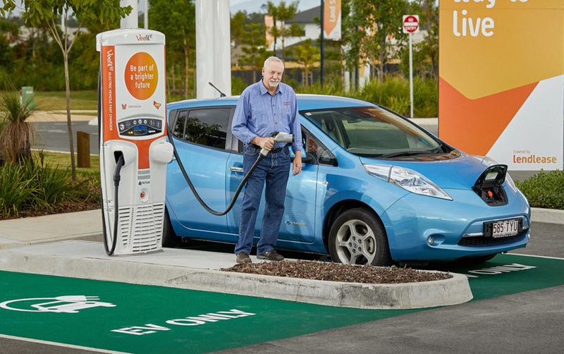 man charging electric vehicle