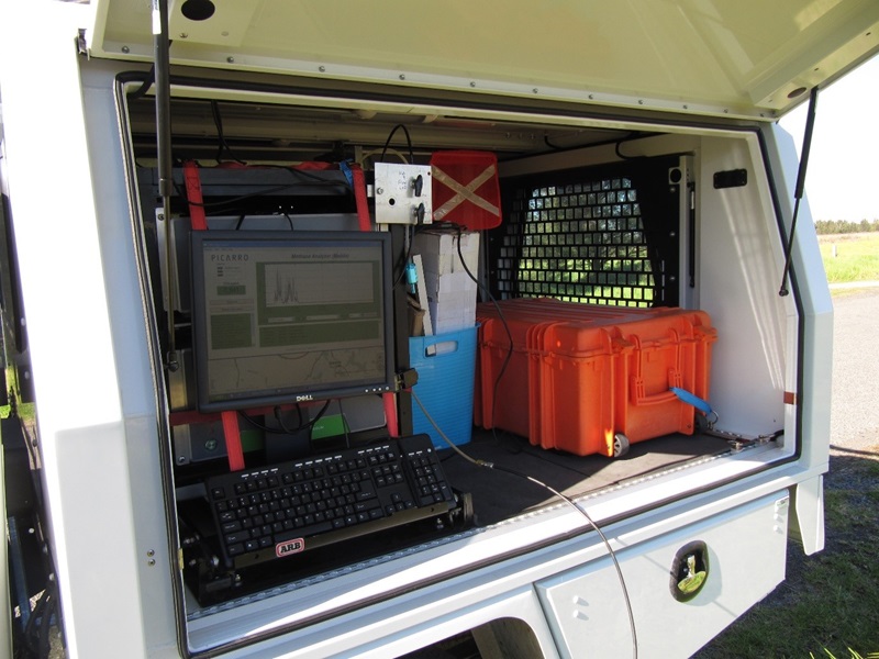 A computer and other electronic equipment sitting in the back of a utility vehicle