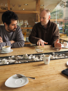 Two men having a discussion over coffee