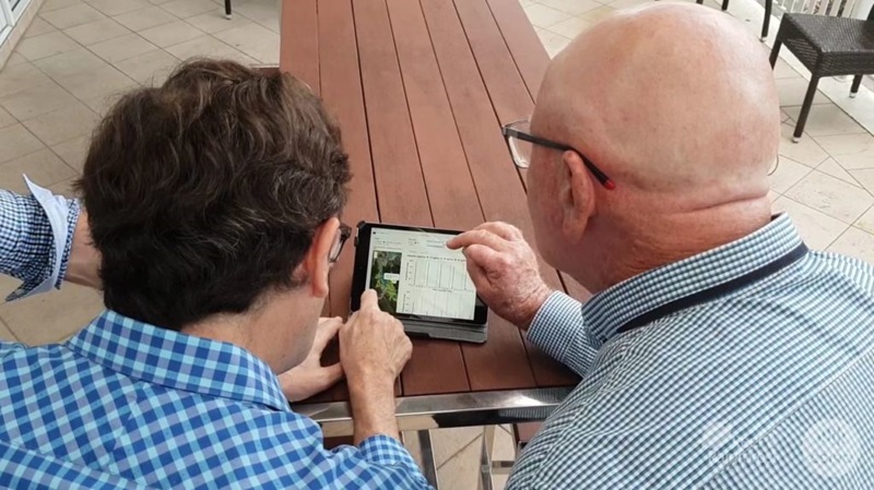 Two people looking at an app on a tablet