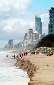 Storm damaged beach with tall buildings