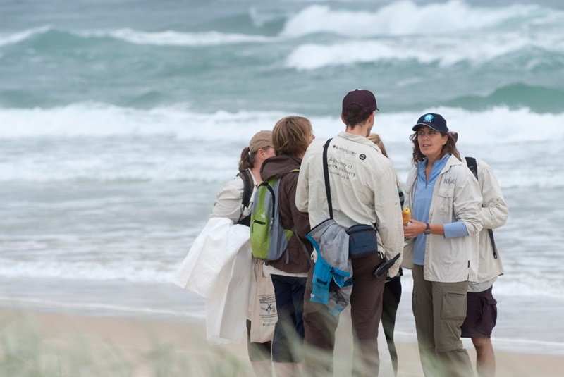 group of researchers on beach