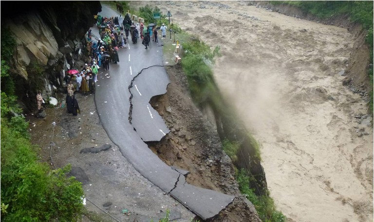 torrential river with road cut off