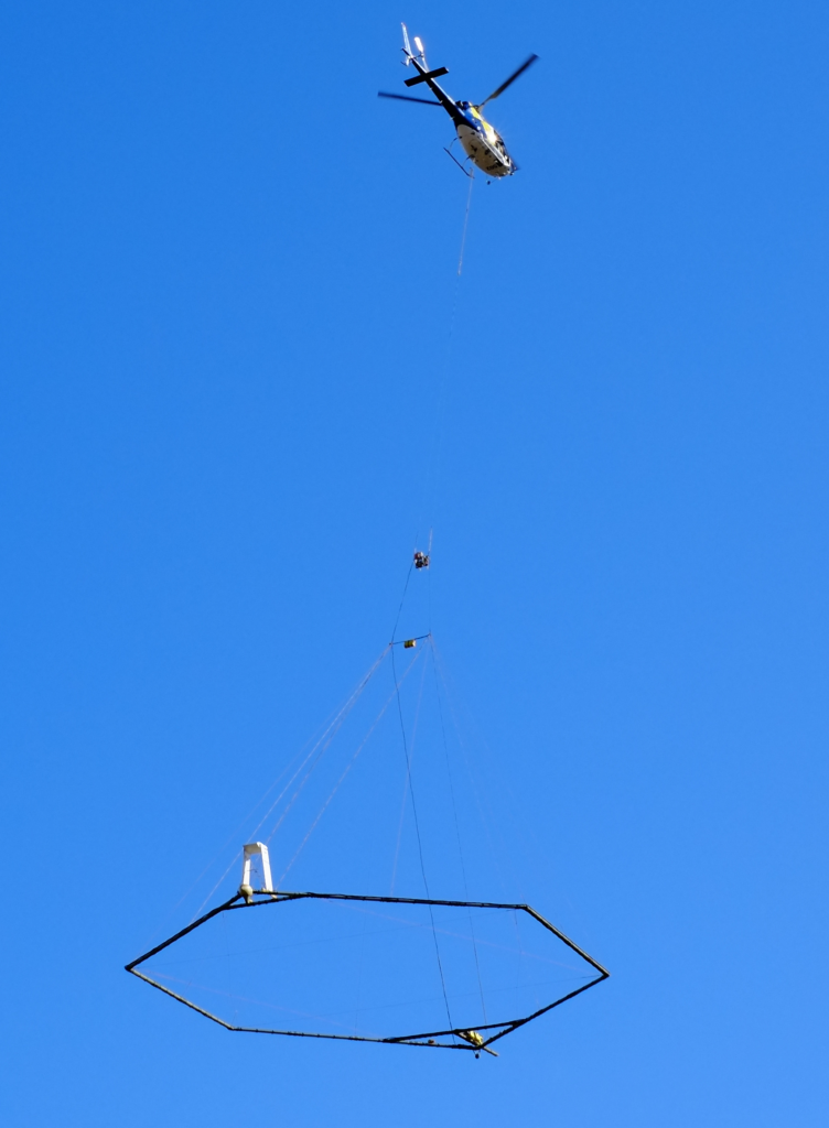 Helicopter conducting the airborne electromagnetic (AEM) surveys.