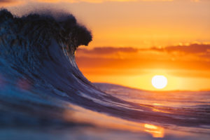 breaking wave at sunset