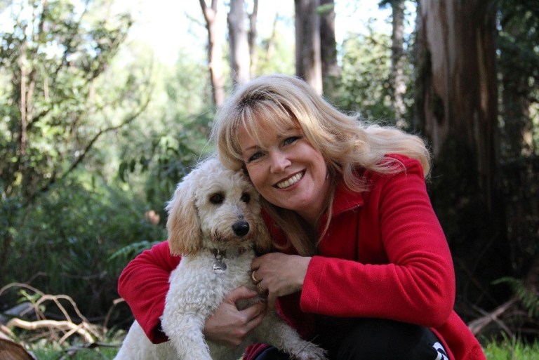 A woman holding a dog