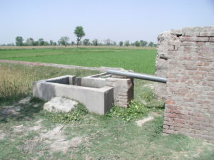 water pump in a green field