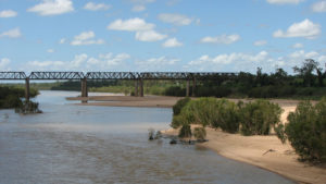 Muddy waters flow through a river 