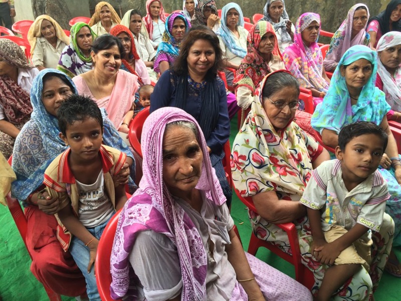 Anu Kumar sits with other women in a workshop setting where she teaches them about pesticide esposure. 