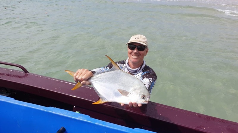 Fisherman with a pompano fish.