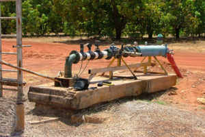 A water bore with mango trees in the background