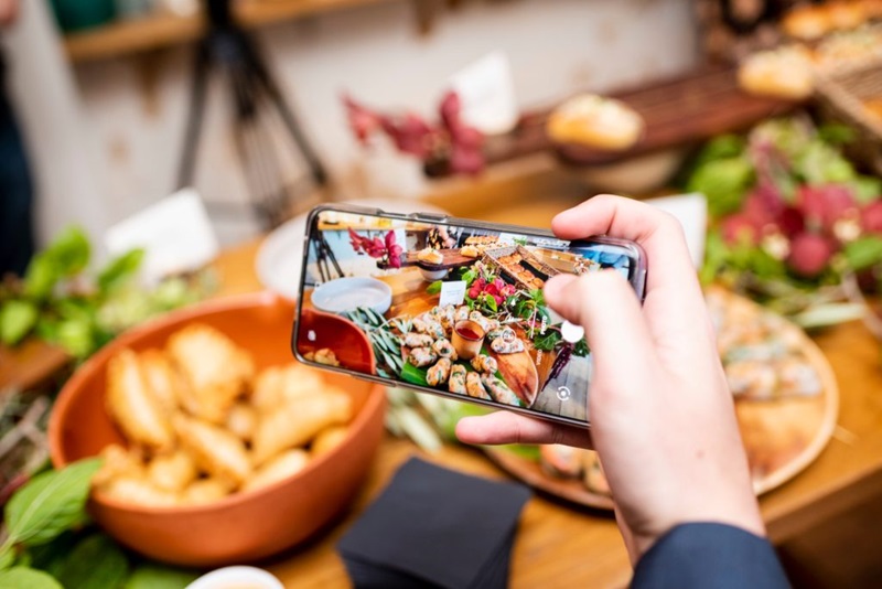 A photo of someone taking a photo of food