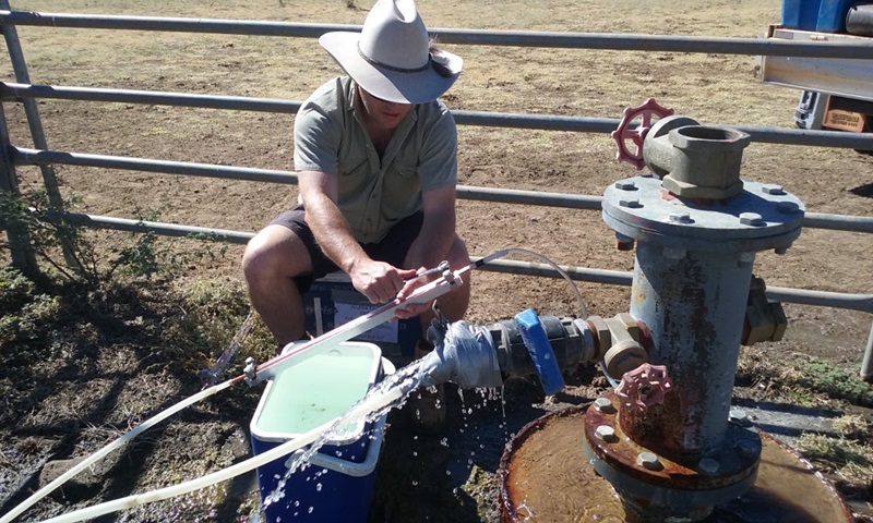 man in hat testing outback water well