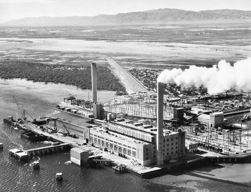 A black and white photo of a power station, taken from the sky