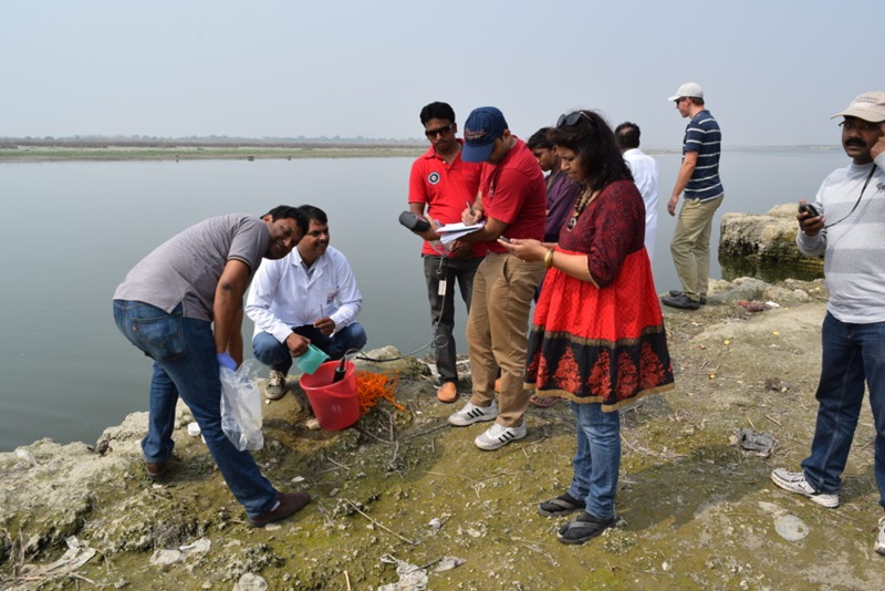 A group of scientists collecting water samples to study pollution in the Ganges, India.