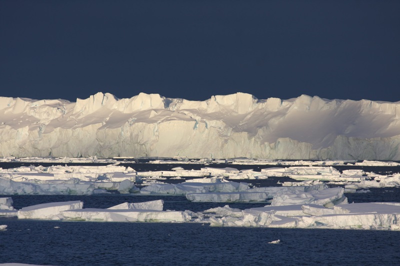The Totten Glacier with blue sky and ocean.