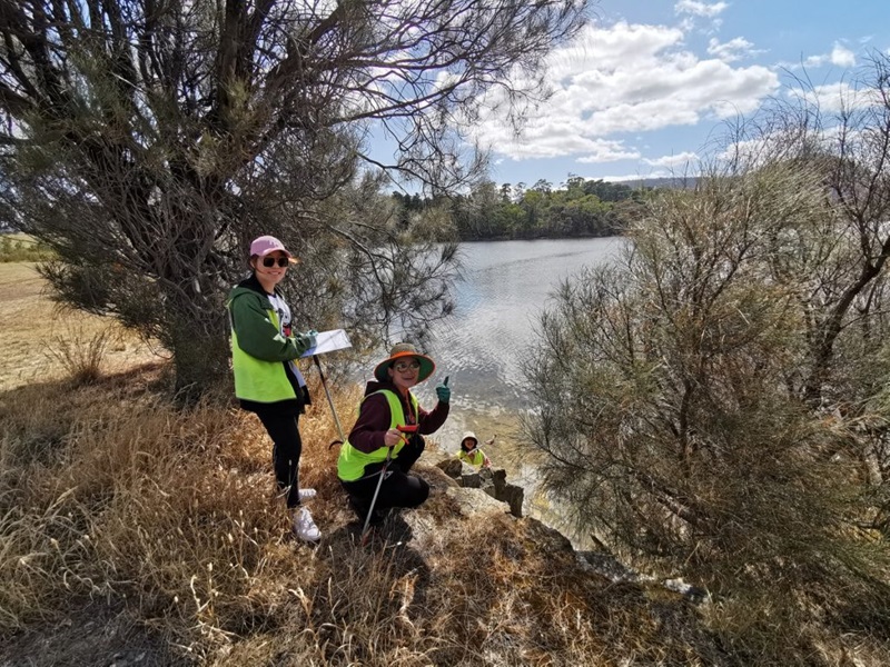 volunteers by a lake