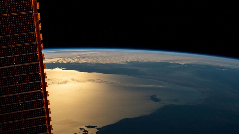 The International Space Station was orbiting above the Northern Territory of Australia when this photograph was taken of the Gulf of Carpentaria including (from bottom left to right) the Pellew Islands, Wellesley Islands and South Wellesley Islands. One of the station's main solar arrays drapes the left side of this photograph.