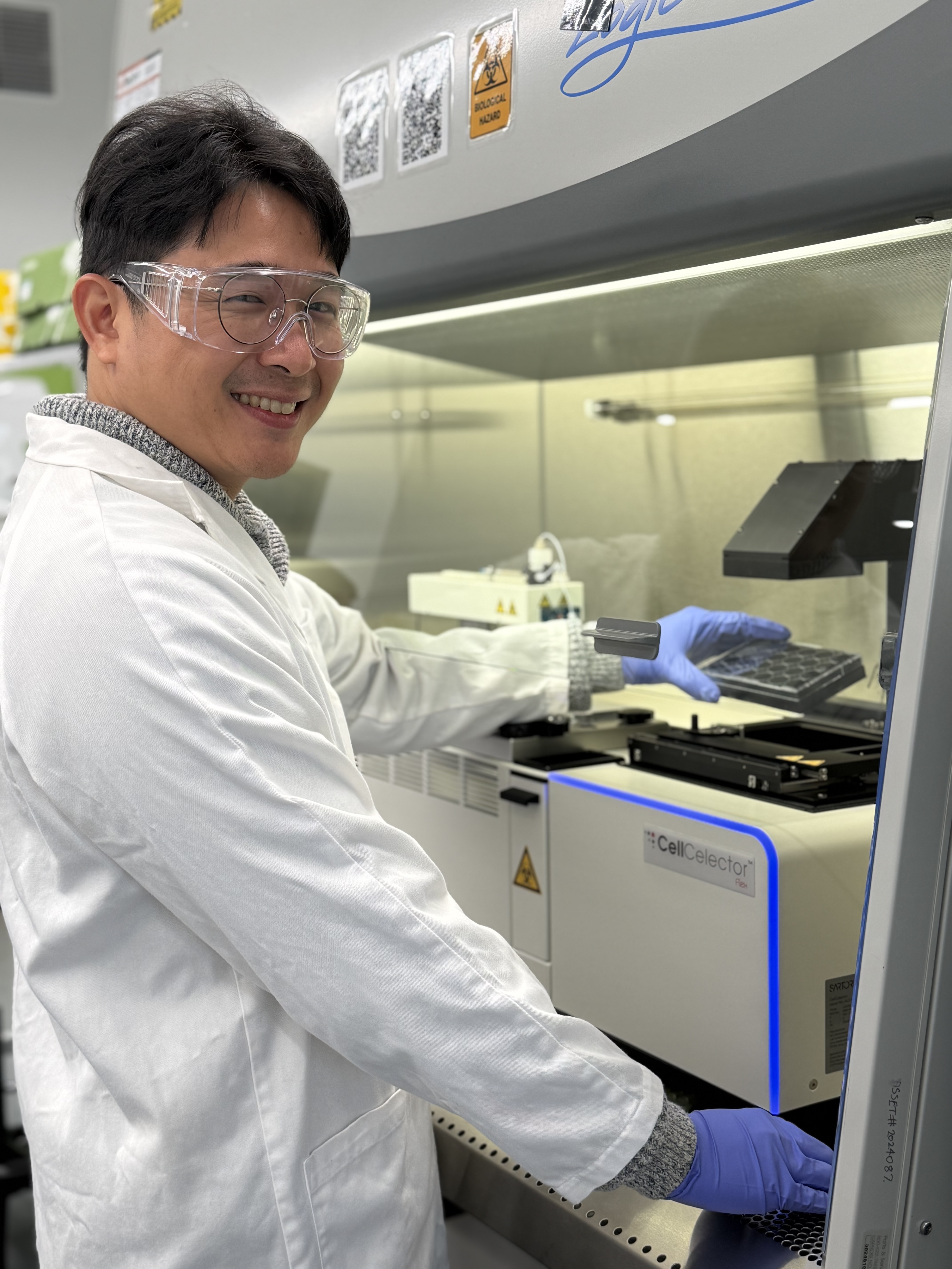 A scientist smiling at the camera
